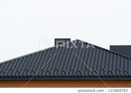 The roof of corrugated black sheet. Roof of a new home 125869763