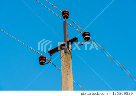 The close up of electricity power cable on concrete pole. Electric power industry 125869889