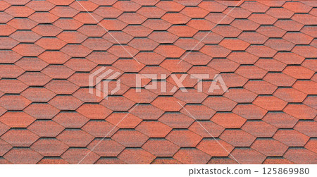 View of red bituminous roof tiles. Asphalt shingles roofing construction. Template for roofers View of red bituminous roof tiles. Asphalt shingles roofing construction. Template for roofers 125869980