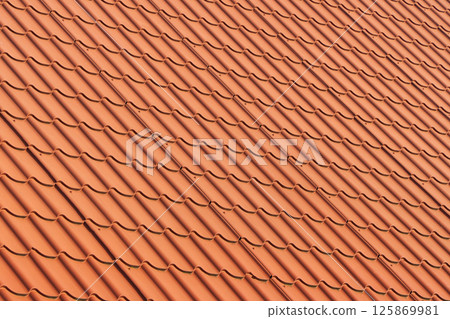 Red tiles roof. Red corrugated tile element of roof Red tiles roof. Red corrugated tile element of roof 125869981