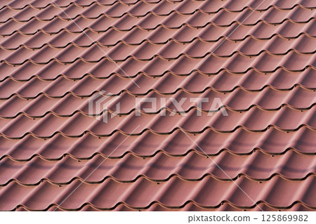Red metal roof tiles. The texture of shingles 125869982