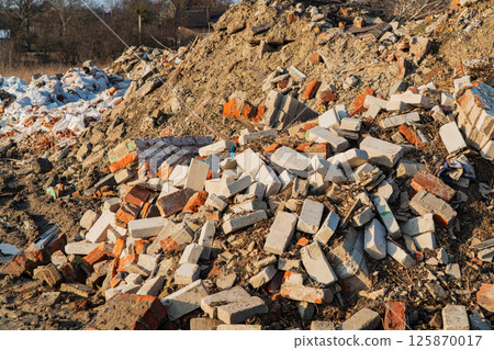 A pile of building bricks. Unused bricks after construction. Garbage remained after construction. Pile of concrete debris 125870017