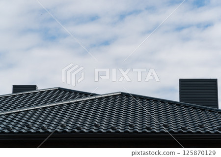 Modern roof of the house made of metal profile. Modern roof made of metal 125870129