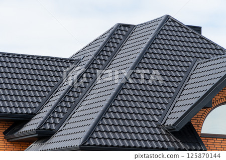 House with a black metal roof. Corrugated metal roof and metal roofing 125870144