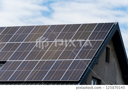 Solar panel on sheet black metal roof 125870145