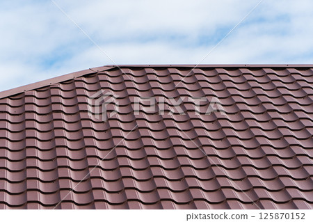 Brown corrugated metal profile roof. Modern roof made of metal Brown corrugated metal profile roof. Modern roof made of metal 125870152