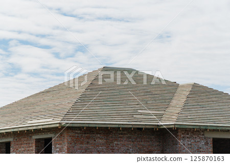 Construction of a new house. New house roof structure. New roof covering 125870163
