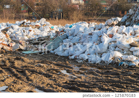 Garbage dump near the houses. Illegal dumping of construction waste 125870183