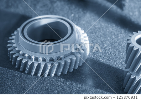 Close up scene small gear shape part from the metal 3D printing method in the light blue scene. Close up scene small gear shape part from the metal 3D printing method in the light blue scene. 125870931