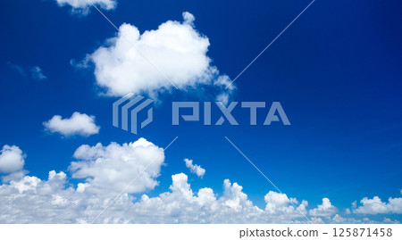 Blue sky with clouds closeup. Blue sky background with tiny clouds 125871458