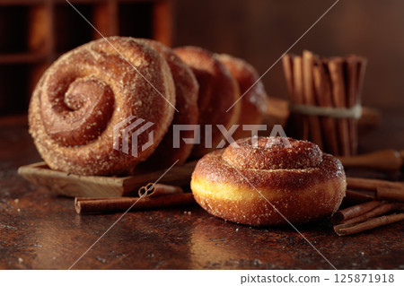 Swedish cinnamon rolls on a brown background. Swedish cinnamon rolls on a brown background. 125871918