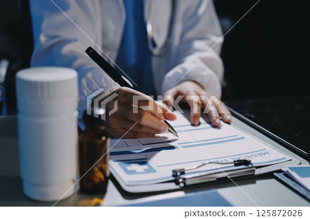 Male and female doctors are having a meeting in a hospital room. 125872026