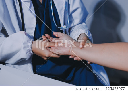 Orthopedist examining patient in hospital Orthopedist examining patient in hospital 125872077