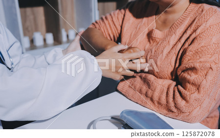 Orthopedist examining patient in hospital 125872078