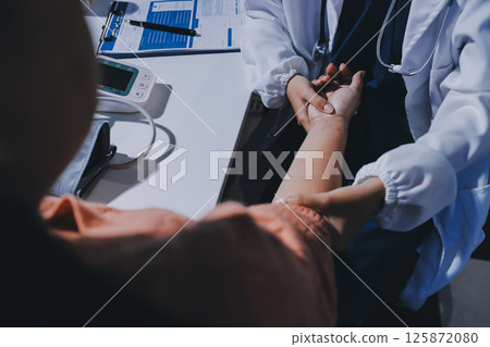 Orthopedist examining patient in hospital 125872080