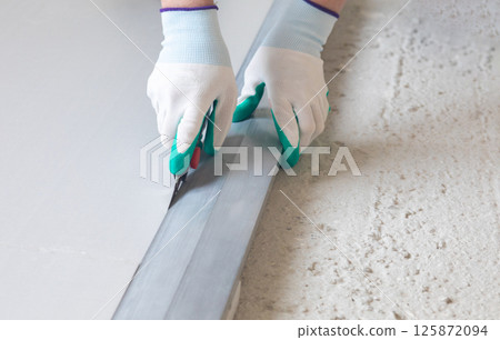 Cutting insulation material on the floor Cutting insulation material on the floor 125872094