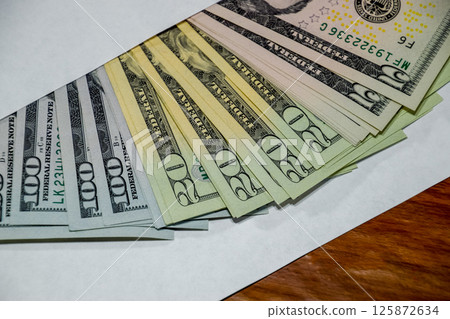 Dollars on table with an envelope. Money in an envelope. U.S. dollars. Dollars on table with an envelope. Money in an envelope. U.S. dollars. 125872634