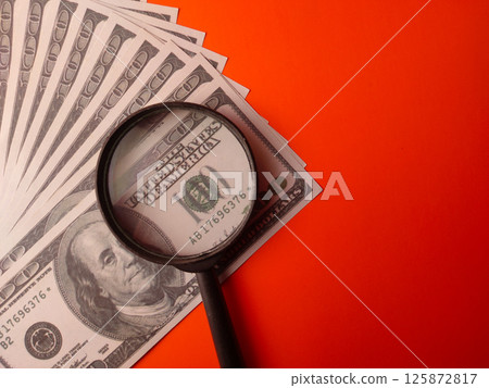 Closeup magnifying glass on a one hundred dollars. Closeup magnifying glass on a one hundred dollars. 125872817