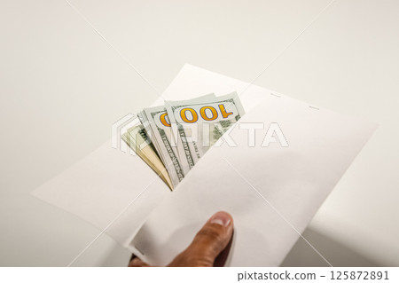 Dollars in a conwind on white background, a lot of money in an envelope. 125872891