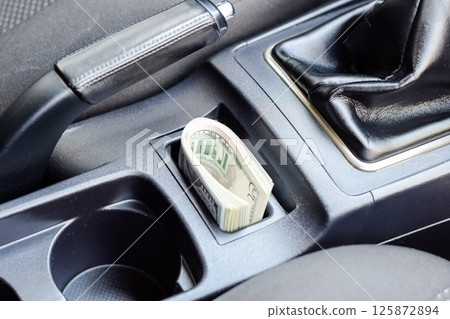 wad of dollars inside the car. 125872894