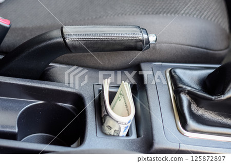 wad of dollars inside the car. 125872897