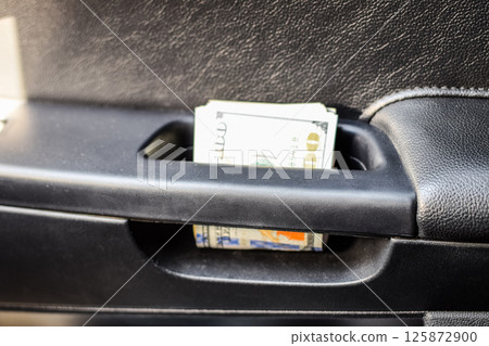 wad of dollars inside the car. wad of dollars inside the car. 125872900