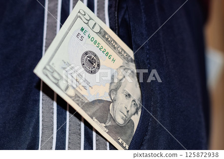 wad of money in the pocket of a man's pants. Dollars in your pocket. 125872938