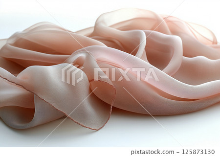 Elegant silk scarf with soft, flowing folds, highlighting its luxurious texture against a simple white background. Elegant silk scarf with soft, flowing folds, highlighting its luxurious texture against a simple white background. 125873130
