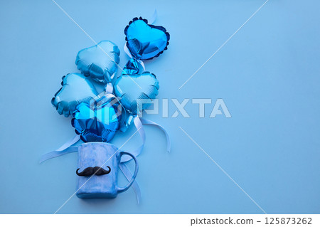 Father's Day scene with a coffee cup and blue heart balloons 125873262