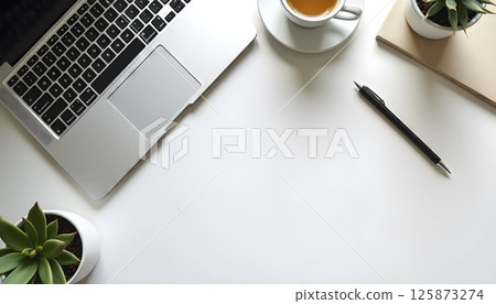 Flat lay top view of modern office desk, laptop, coffee, notebook, pen, minimalist aesthetic, natural lighting 125873274