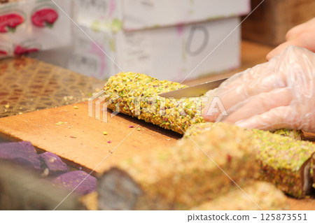 cutting turkish delight in a busy market cutting turkish delight in a busy market 125873551