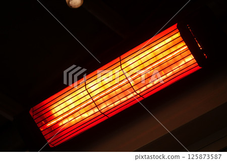 Bright heater radiating warmth in a cozy indoor space Bright heater radiating warmth in a cozy indoor space 125873587