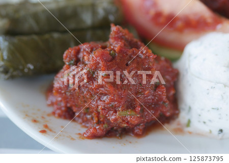 Freshly made spicy tomato dip served with traditional sides 125873795