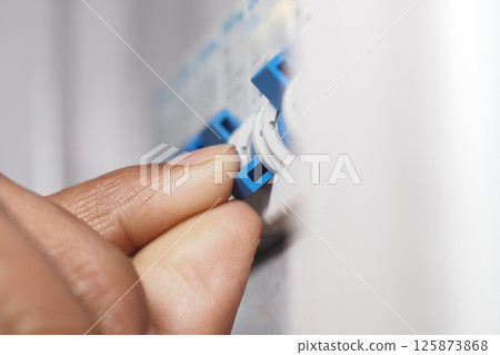 Adjusting the settings on an electrical control panel during repairs 125873868