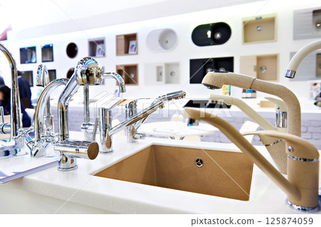 Exhibition of kitchen sinks and taps in store Exhibition of kitchen sinks and taps in store 125874059