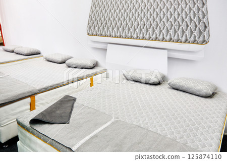 Gray mattress on double bed in store 125874110