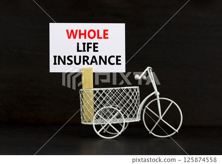 Whole life insurance symbol. Concept words Whole life insurance on beautiful white paper on clothespin. Beautiful black background. Miniature bicycle. Business whole life insurance concept Copy space 125874558