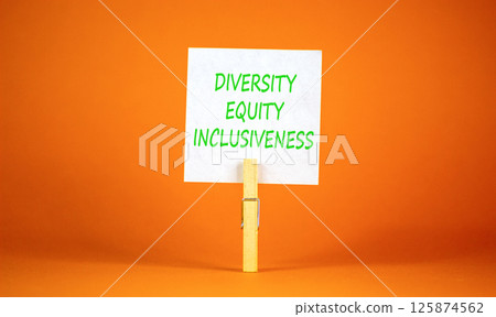 DEI diversity equity inclusiveness symbol. Concept words Diversity Equity Inclusiveness on white paper. Beautiful orange background. Business DEI diversity equity inclusiveness concept. Copy space. 125874562