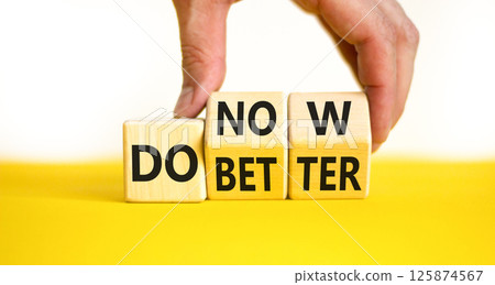 Do better and now symbol. Concept words Do better Do now on wooden block. Beautiful yellow table white background. Businessman hand. Business do better and now concept. Copy space. Do better and now symbol. Concept words Do better Do now on wooden block. Beautiful yellow table white background. Businessman hand. Business do better and now concept. Copy space. 125874567
