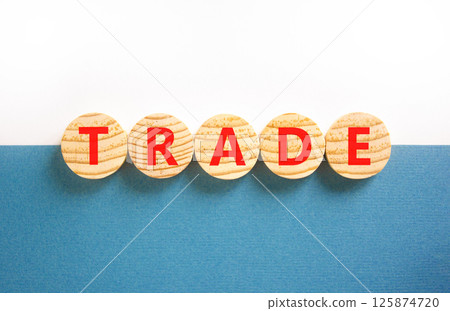 Trade symbol. Concept word Trade on beautiful wooden circles. Beautiful white and blue background. Business lifestyle trade concept. Copy space. 125874720