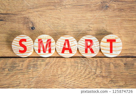 Smart symbol. Concept word Smart on beautiful wooden circles. Beautiful wooden table wooden background. Business lifestyle smart concept. Copy space. Smart symbol. Concept word Smart on beautiful wooden circles. Beautiful wooden table wooden background. Business lifestyle smart concept. Copy space. 125874726