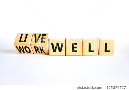Live or work well symbol. Concept words Live well Work well on wooden cubes. Beautiful white table white background. Business and live or work well concept. Copy space. 125874727