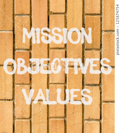 Mission objectives values symbol. Concept words Mission Objectives Values on beautiful brown brick wall. Beautiful brown brick wall background. Business mission objectives values concept. Copy space. Mission objectives values symbol. Concept words Mission Objectives Values on beautiful brown brick wall. Beautiful brown brick wall background. Business mission objectives values concept. Copy space. 125874754