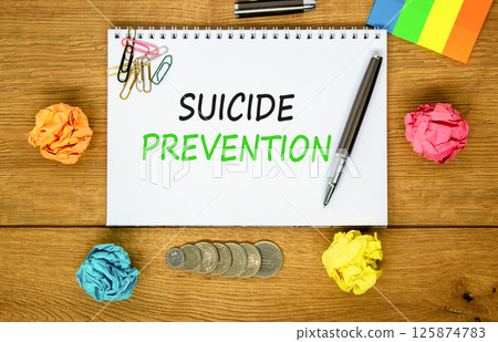 Suicide prevention symbol. Concept words Suicide prevention on beautiful white note. Beautiful wooden table wooden background. Black pen. Psychological suicide prevention concept. Copy space. Suicide prevention symbol. Concept words Suicide prevention on beautiful white note. Beautiful wooden table wooden background. Black pen. Psychological suicide prevention concept. Copy space. 125874783
