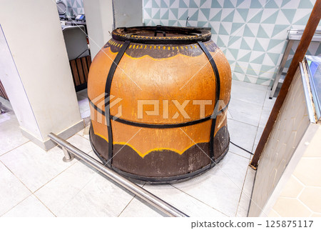 Large gas heated tandoor oven for making traditional asian flat bread Large gas heated tandoor oven for making traditional asian flat bread 125875117