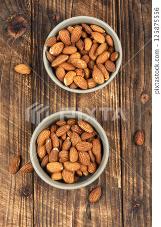 Almond oil with almond seeds. 125875556
