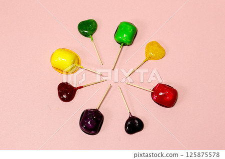 Colorful lollipops on a pink background Colorful lollipops on a pink background 125875578