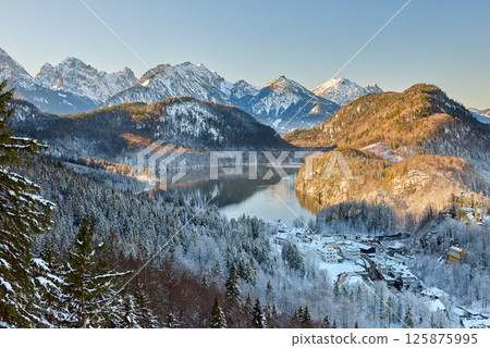 Breathtaking Snowy Mountain Landscape with Lake Near Neuschwanstein Castle in Germany at Dawn 125875995