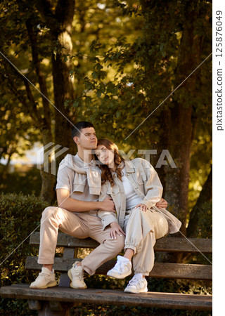 Young Cute Female Hugs Boyfriend. In Autumn Outdoor. Lovers Walking in Park. Attractive Funny Couple. Lovestory in Forest. Man and Woman. Cute Lovers in the Park. Family Concept. Happy Couple. 125876049