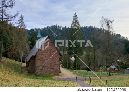 Scenic Countryside Landscape with a Small Brick Chapel and Traditional Houses in a Green Valley of the Black Forest, Germany 125876068
